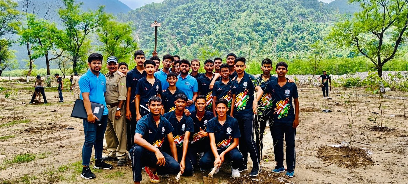 Students and forest staff at a plantation drive in the hills